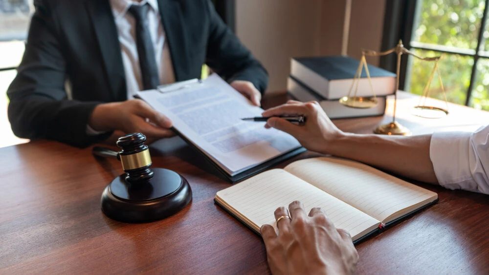 Male Notary lawyer or judge consult or discussing contract papers with Businessman